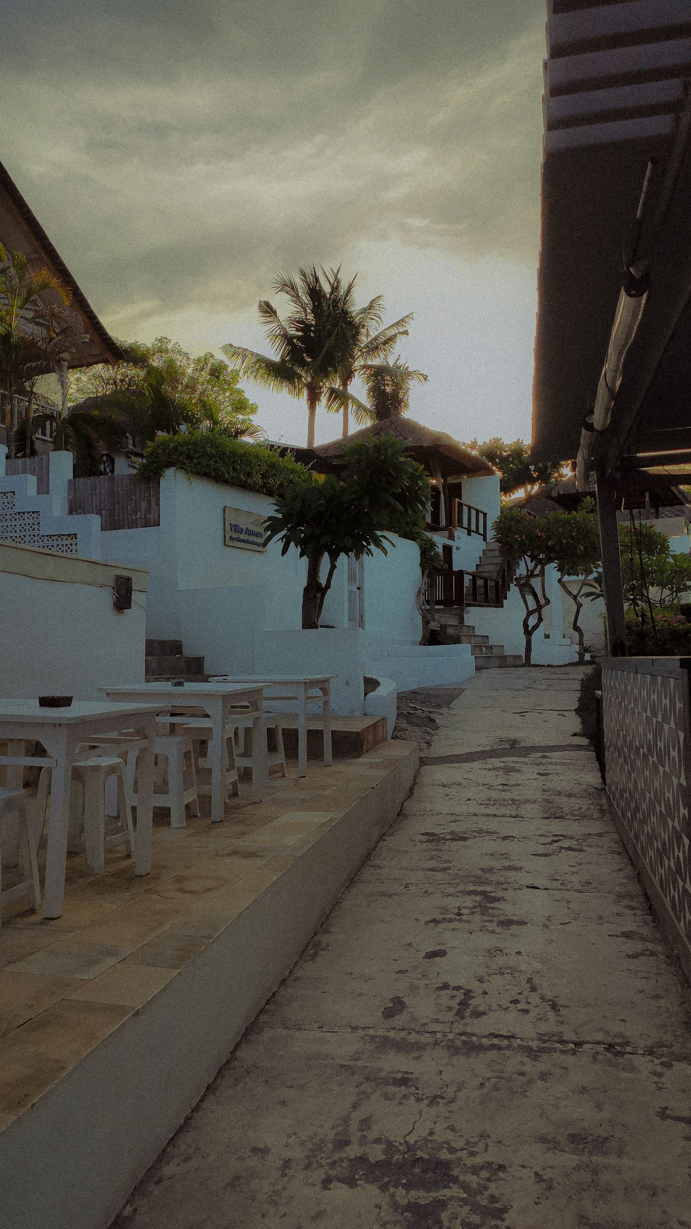 A boutique hotel courtyard with tables at dusk
