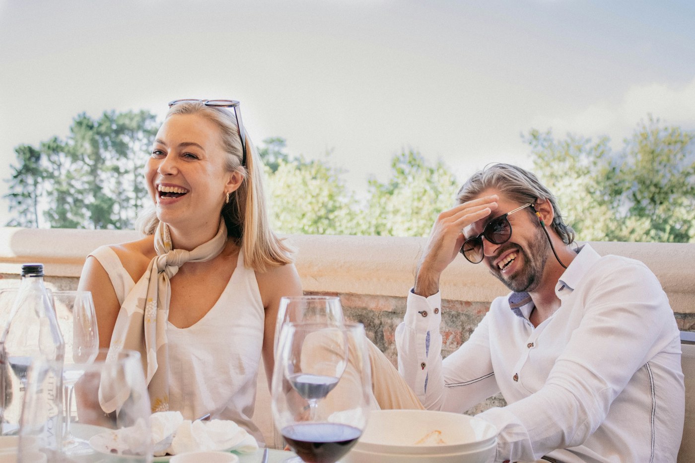 A man and a woman leaning in over a restaurant table