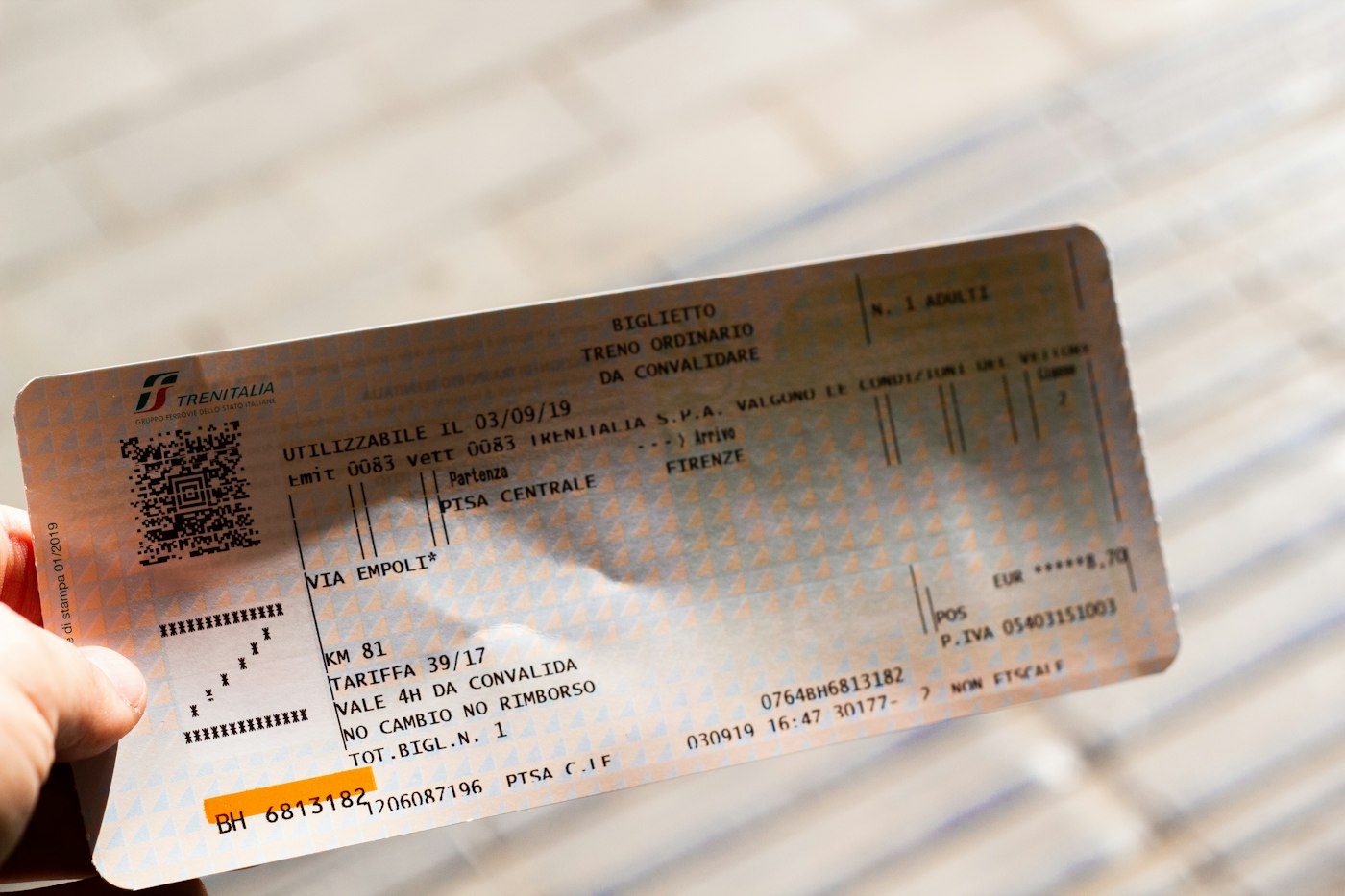 A close-up of a hand holding a ticket